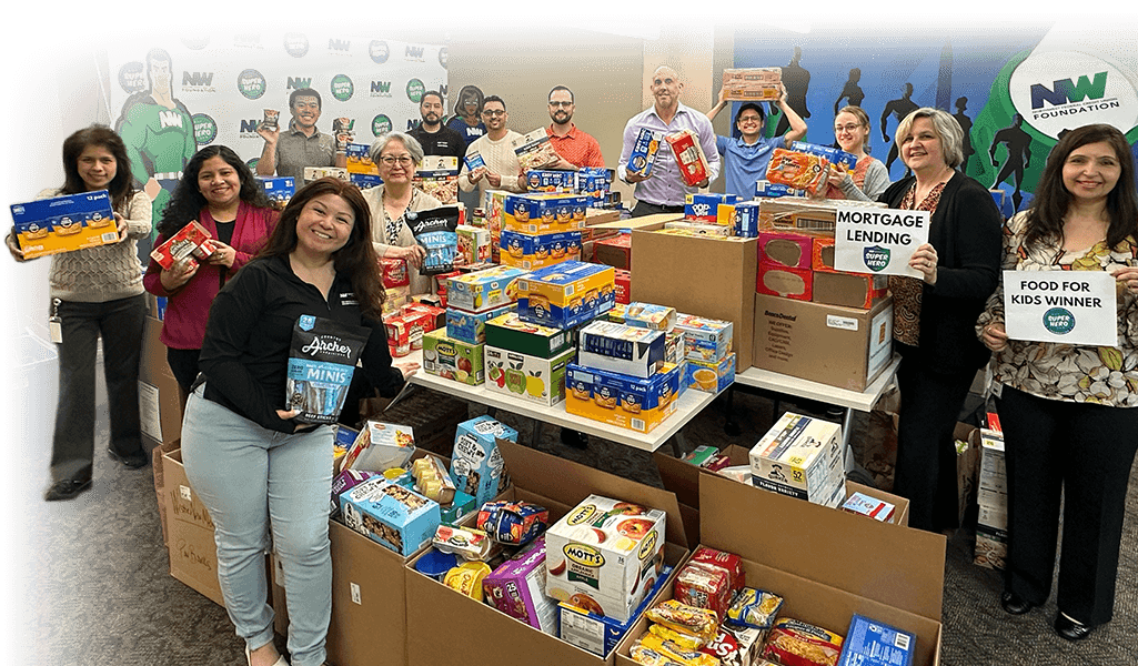 NWFCU Foundation staff members holding up donated food for the Food For Kids program