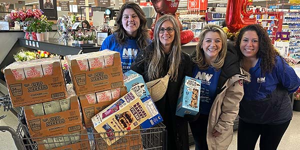 NWFCU Foundation staff shopping for the Food For Kids program at a Giant store