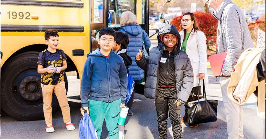 Children boarding a school bus together in Northern Virginia community.