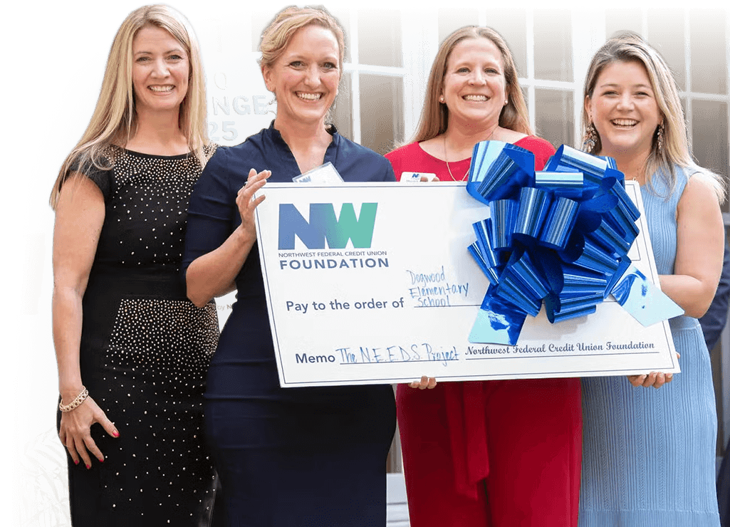 Foundation representative holding large donation check for youth support programs.