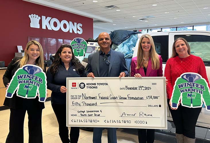 Koons Toyota representative gives donation check to the NWFCU Foundation