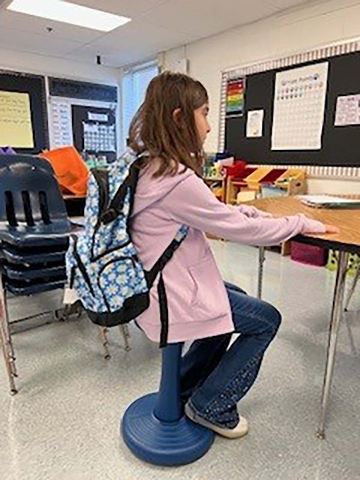 Student using a NWFCU Foundation provided wobble stool