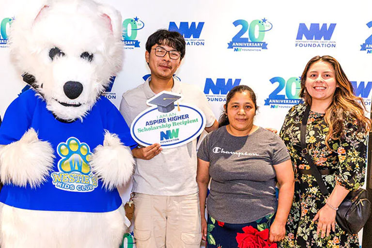 Students receiving scholarship awards from Northwest Federal Credit Union Foundation representatives.